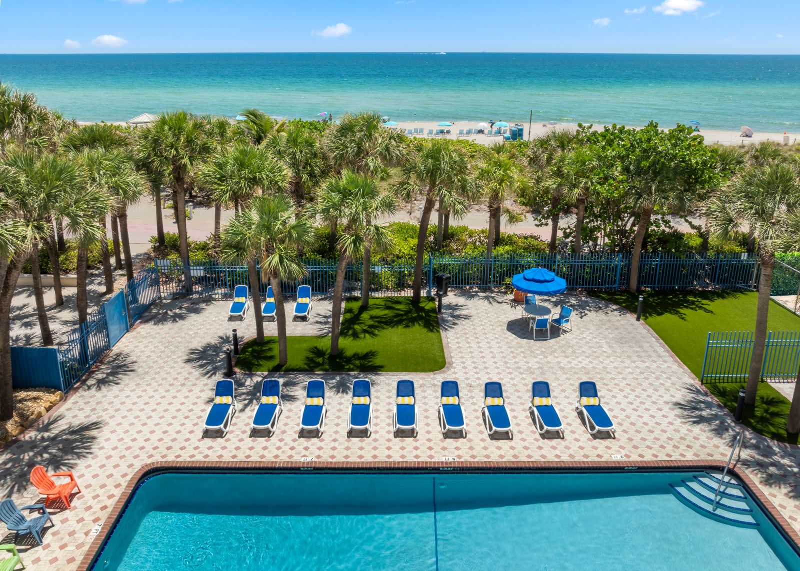Oceanfront pool with lounge chairs at Miami Beach hotel | Crystal Beach Suites Hotel